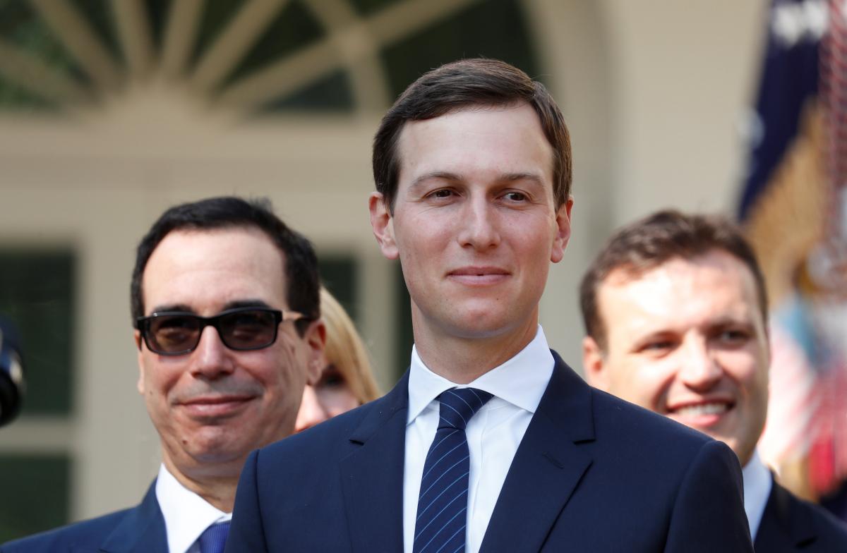 White House senior advisor Jared Kushner (C) and Treasury Secretary Steven Mnuchin (L) wait in the Rose Garden prior to President Donald Trump's news conference on the United States-Mexico-Canada Agreement (USMCA) at the White House in Washington, U.S., October 1, 2018. REUTERS/Leah Millis