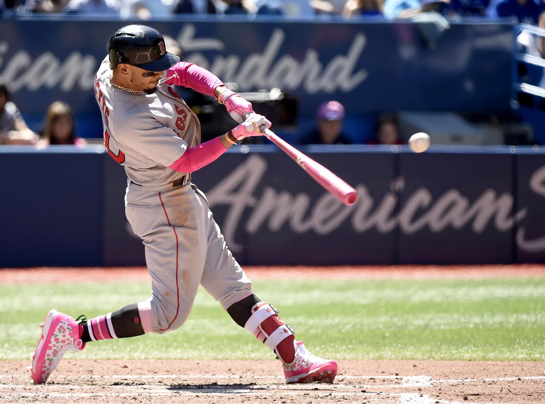 Boston Red Sox's Mookie Betts hits a single during fifth-inning baseball game action against the Toronto Blue Jays in Toronto, Sunday, May 13, 2018. (Nathan Denette/The Canadian Press via AP)