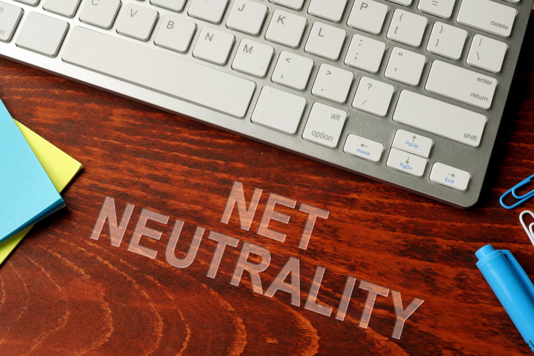 Net neutrality written on a wooden surface. Neutral internet concept.