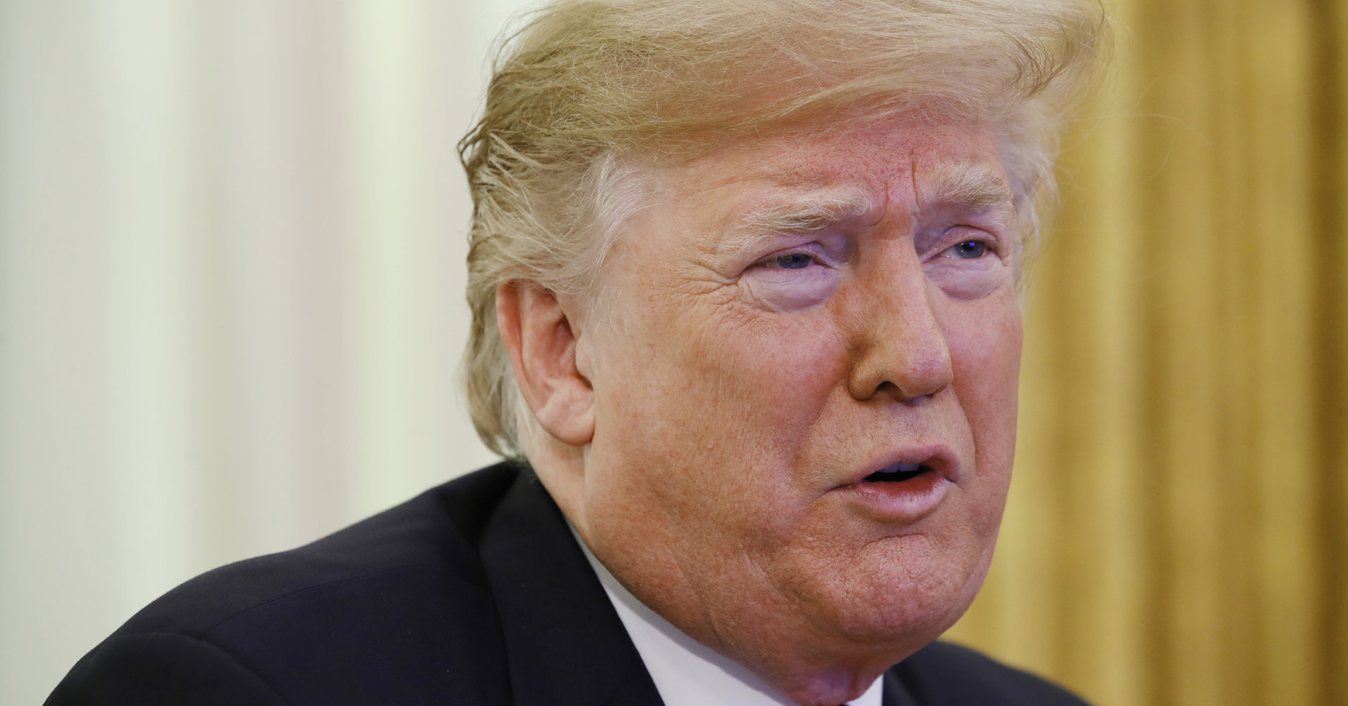 President Donald Trump greets members of the five branches of the military by video conference on Christmas Day, Tuesday, Dec. 25, 2018, in the Oval Office of the White House. The military members were stationed in Guam, Qatar, Alaska, and two groups in Bahrain. (AP Photo/Jacquelyn Martin)