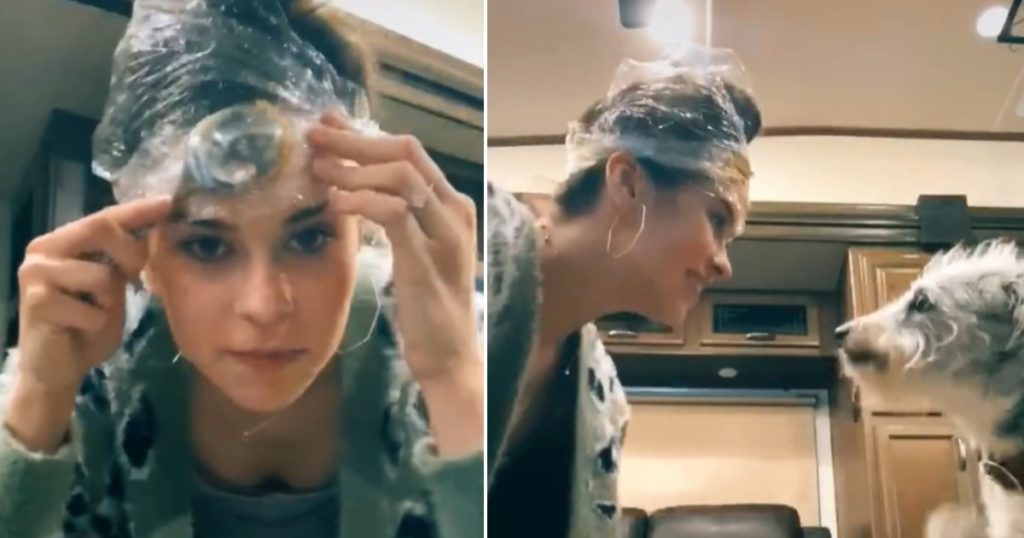 Woman smears peanut butter on her forehead to clip her dog's nails