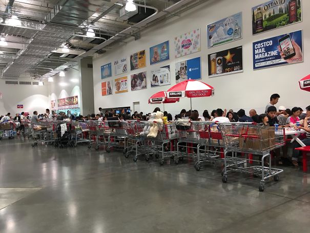 People in Japan lineup their carts in the Costco in the food court