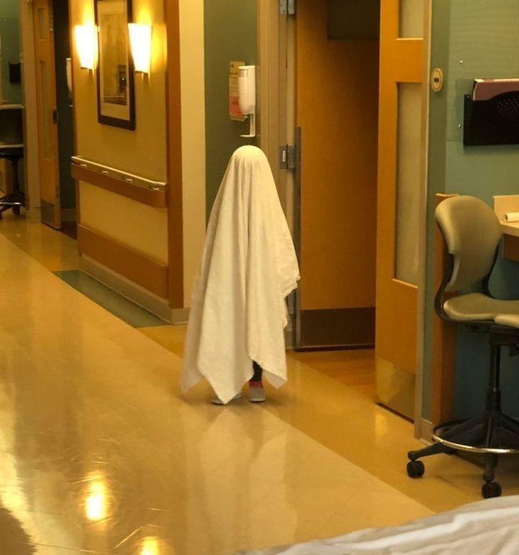 My daughter pretending to be a ghost at the hospital. Probably a poor choice