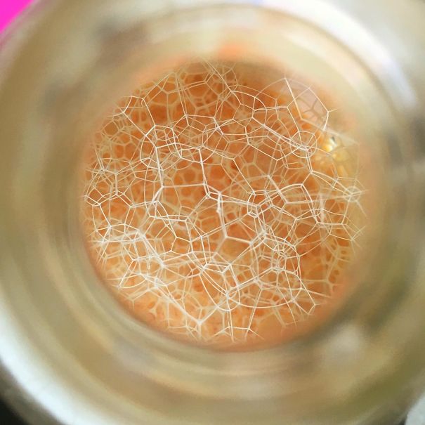 Bubbles Seen Through The Top Of The Shampoo Bottle