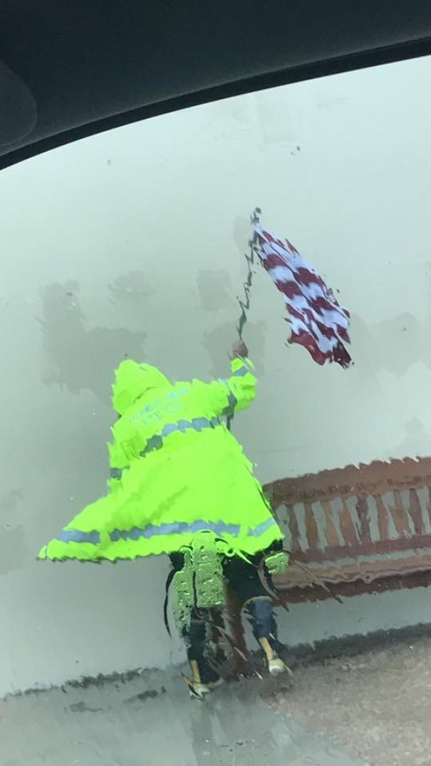 Police Officer Trying To Save American Flag During Hurricane Harvey Looks Like A Painting