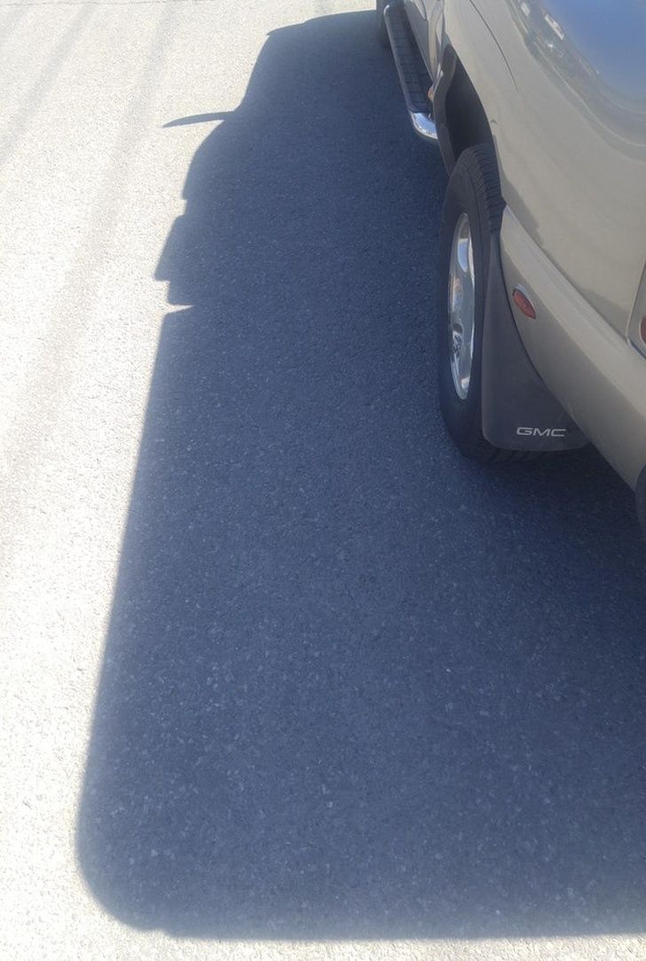This car's shadow looks like a happy cowboy with a giant chin