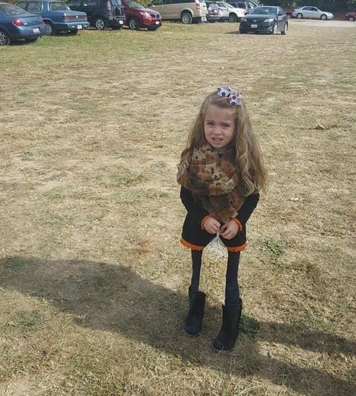 The girl with thin limbs? No, she is posing with a bag of popcorn!