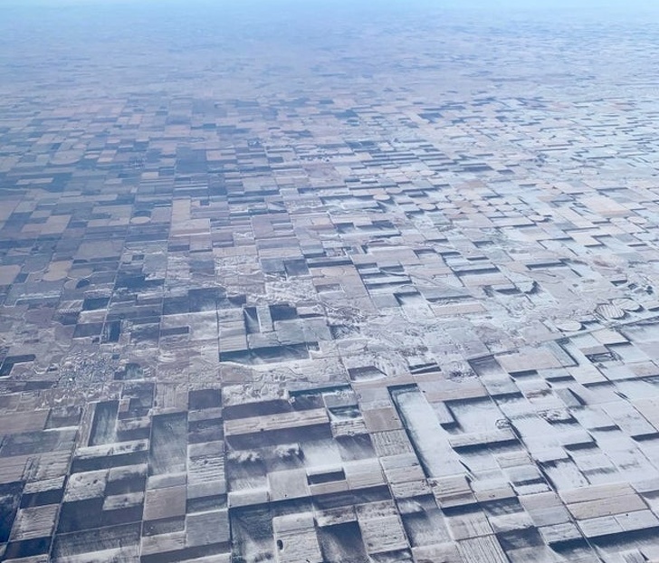 This flat farmland in eastern Colorado has snow patches that create a 3D illusion