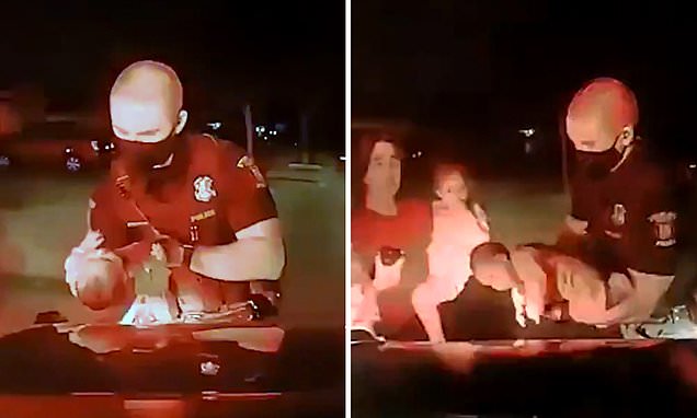 Heartstopping moment a Michigan cop saves a three-week-old baby from choking as desperate mom collapses on the ground and helpless family members look on