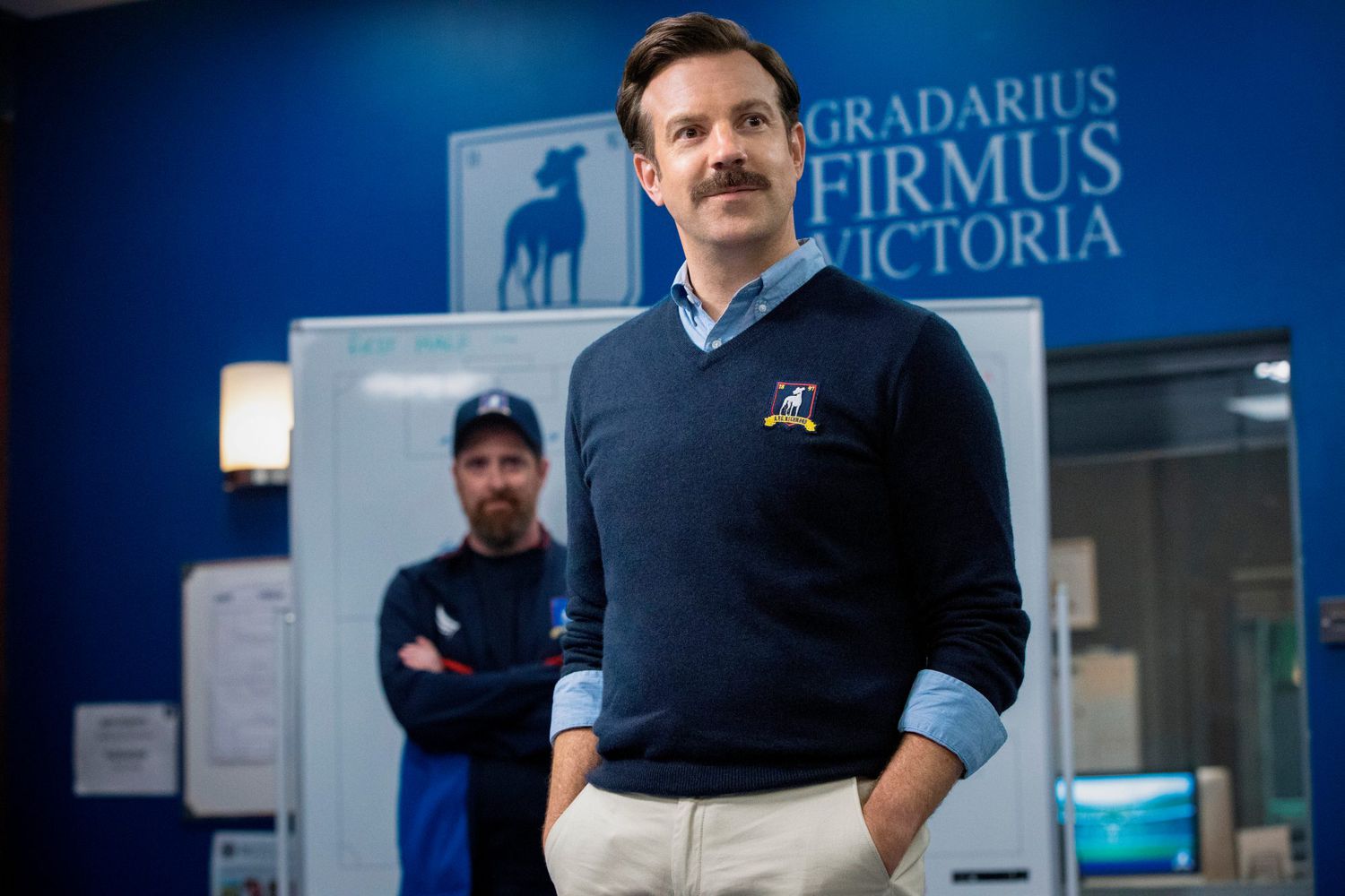 Jason Sudeikis as Ted Lasso, the beloved American football coach in England.