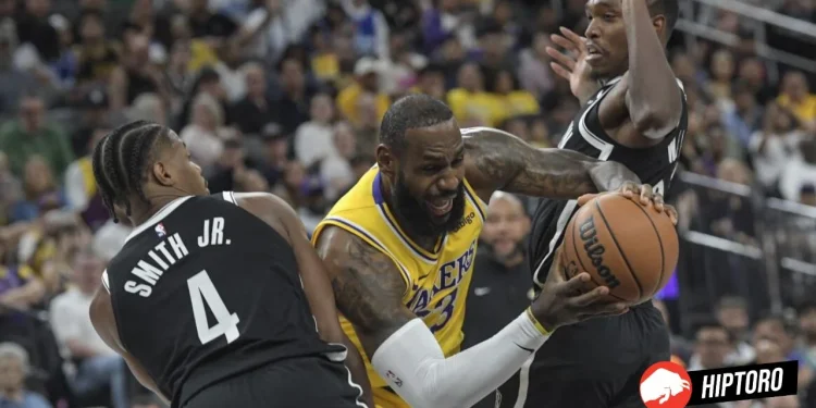 Los Angeles Lakers forward LeBron James, center, drives between Brooklyn Nets guards Dennis Smith Jr. (4) and Lonnie Walker IV, right, during the first half of a preseason NBA basketball game Monday, Oct.